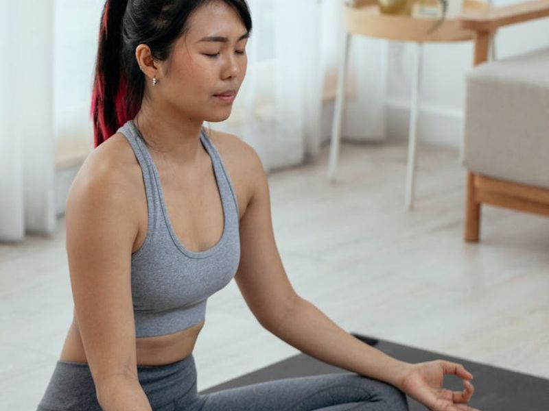 Woman in a graceful yoga pose with soft light accents.